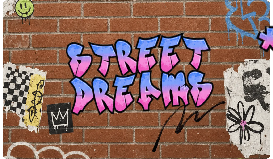 Street Dreams in blue-to-pink gradient graffiti letters spray-painted on a brick wall